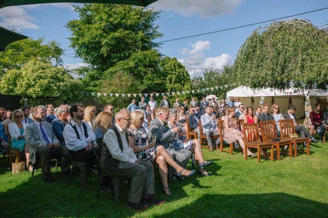 Guests seated at an outdoor garden wedding in Oxfordshire