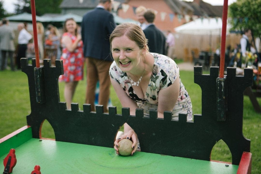 Happy guest playing lawn games at an Oxford garden wedding