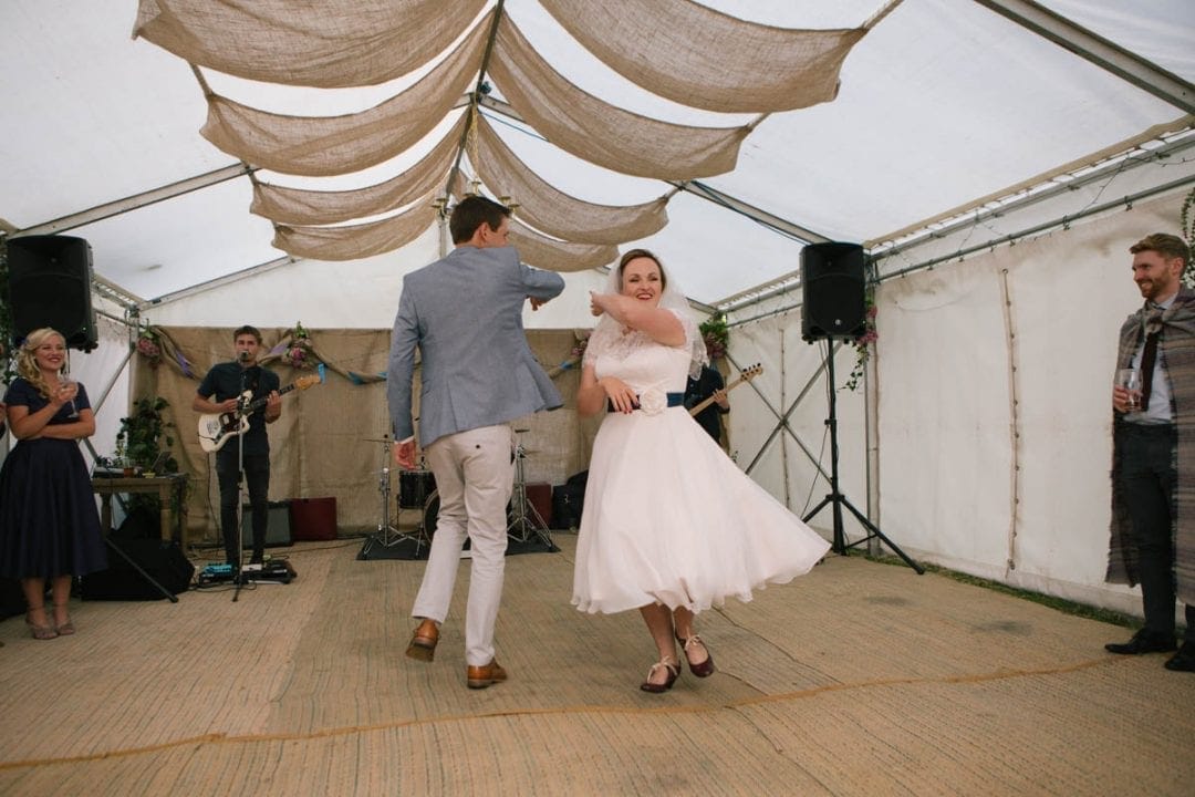Bride and groom first dance in a marquee