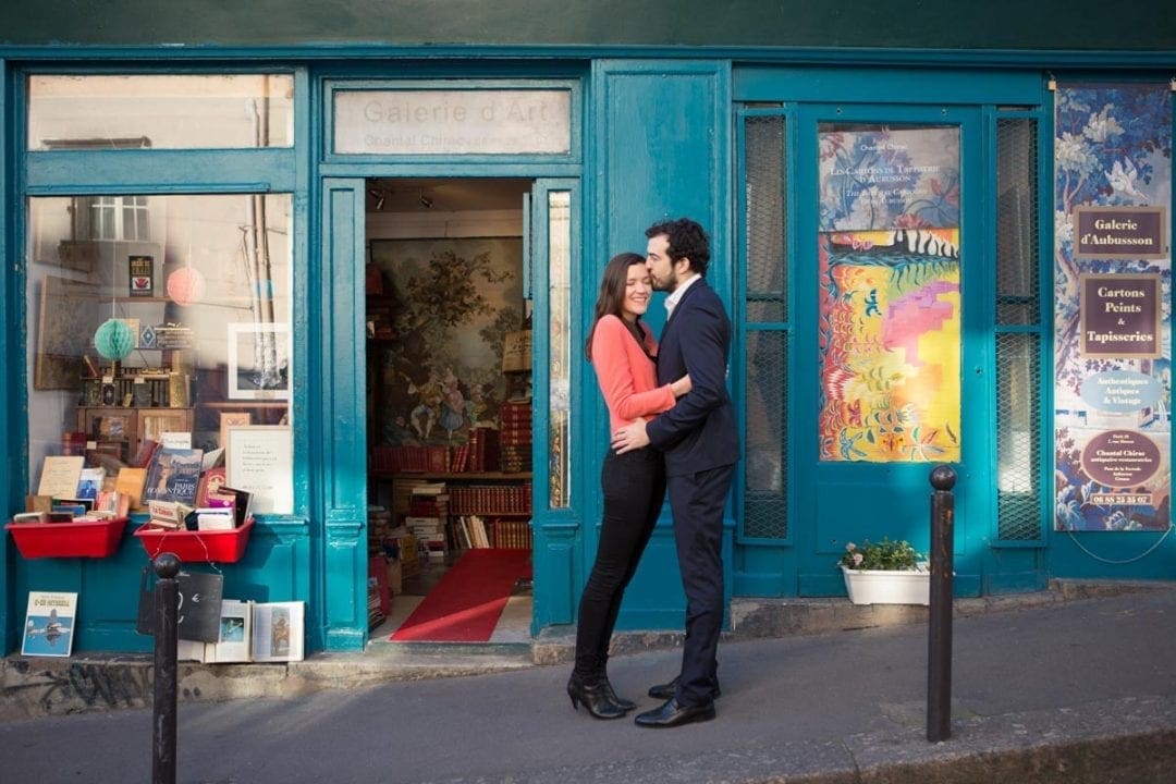 Couple huging in front of a Bohemian bookstore in Paris