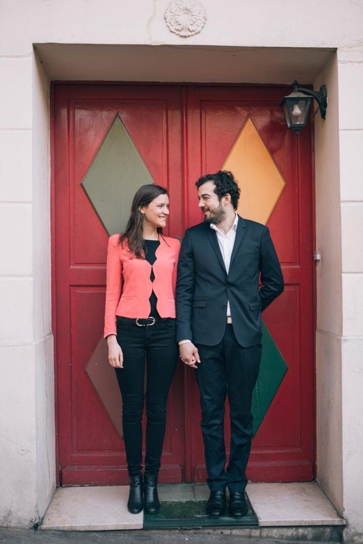 Couple in a red doorway in Paris
