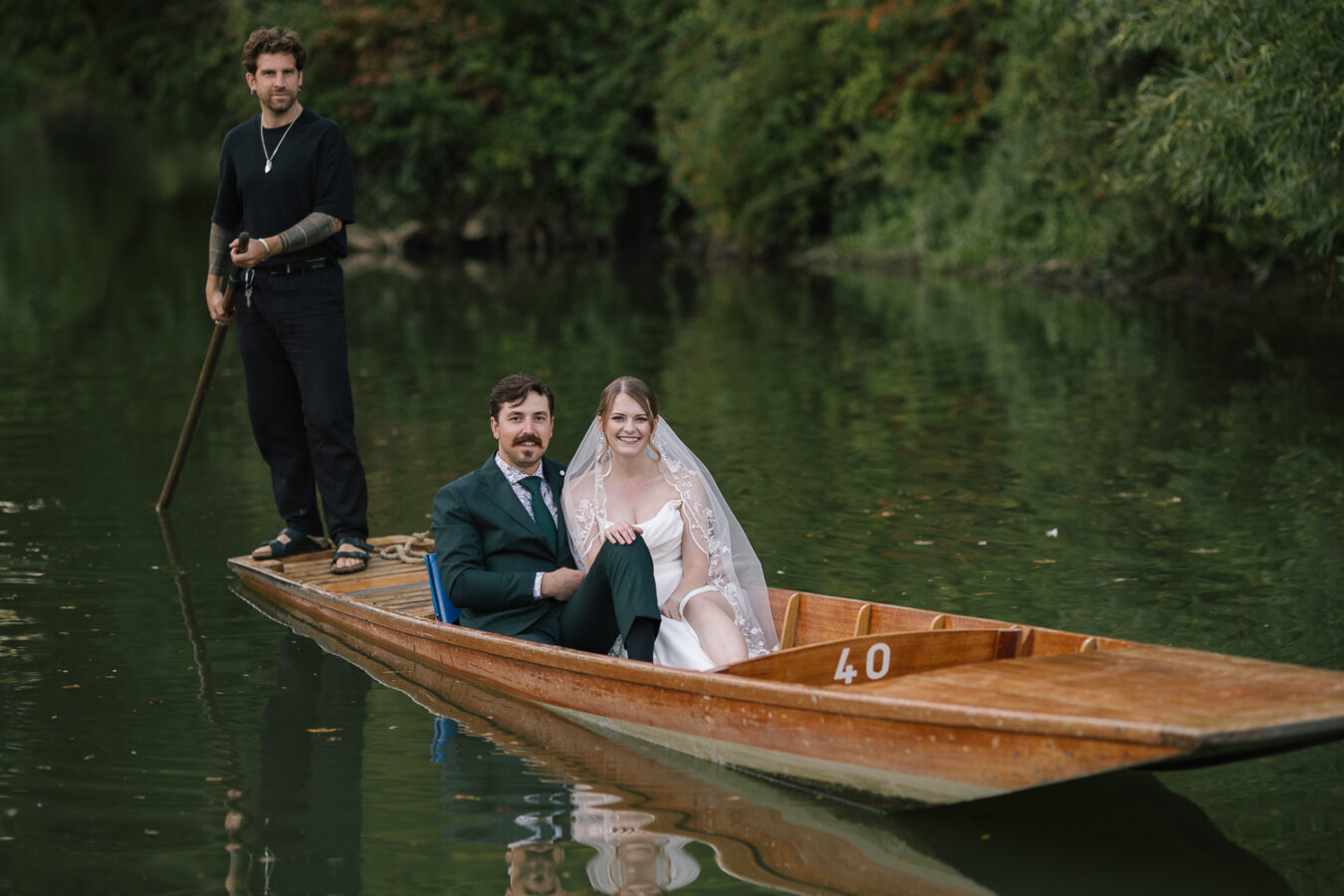 Newlyweds on a romantic punt ride through Oxford’s tranquil waterways, starting at the Cherwell Boathouse