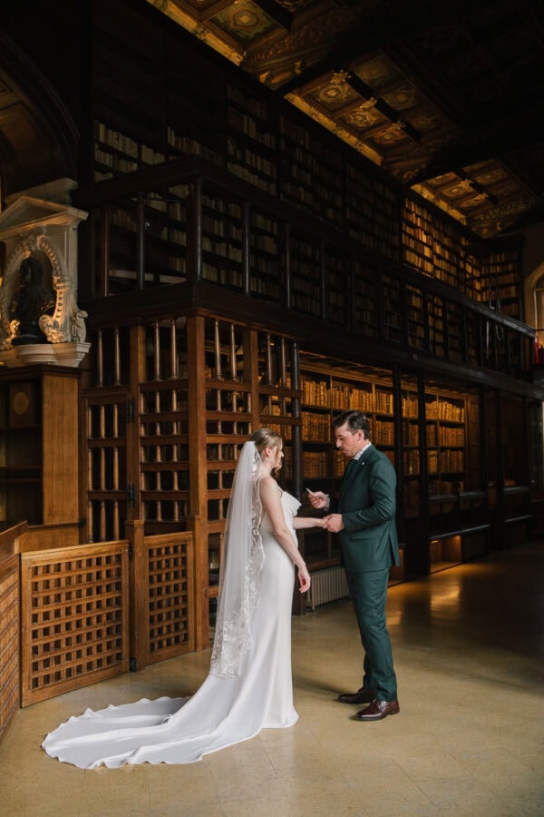 Bride and groom share vows between the towering shelves of Duke Humfrey’s Library in Oxford