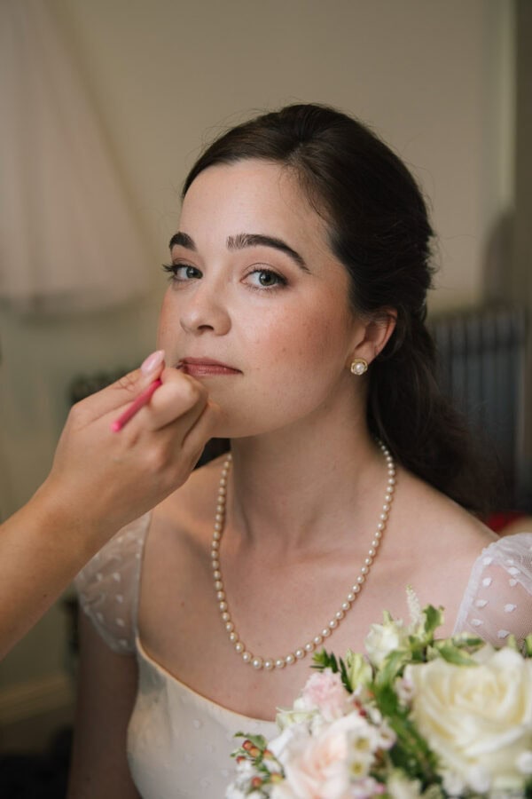bride having her makeup applied